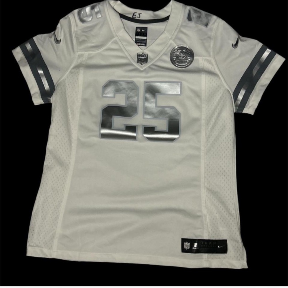 Woman white and silver NFL jersey #25